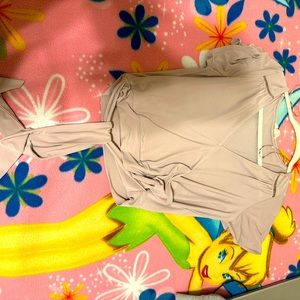 It’s a cross back shirt the v neck isn’t that low it’s pretty and hardly worth